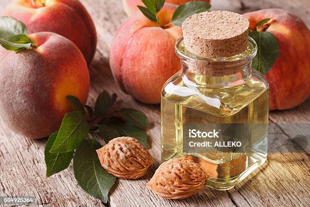 Cosmetic Oil Peach In A Glass Bottle On Table Closeup Stock Photo - Download Image Now
