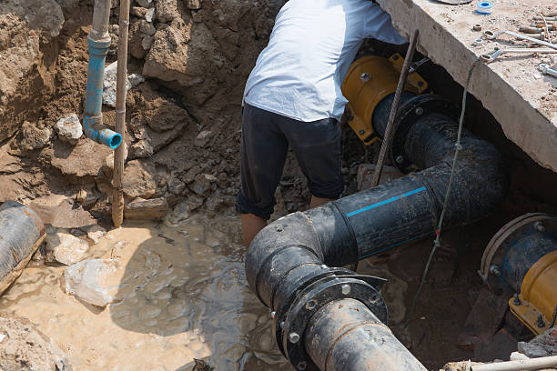 istock man fixing drainage pipe for dirty water 504925926