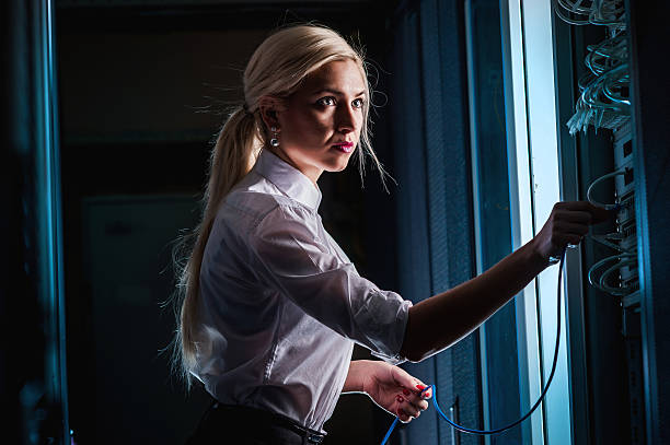 istock Young engineer businesswoman in server room 504926210