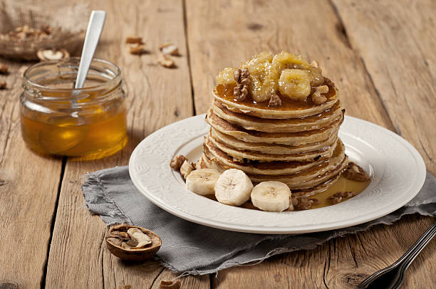istock pancakes with banana, nuts and honey 504926904