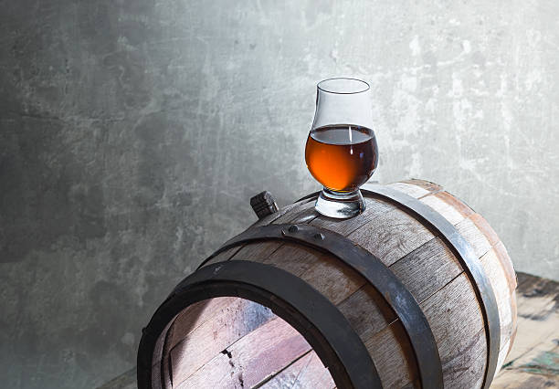 istock Glass of whiskey on a old barrel 504927542