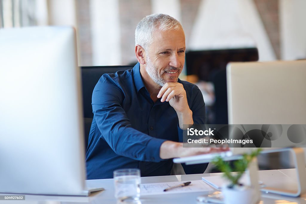 Making use of online resources Cropped shot of a mature businessman working at his deskhttp://195.154.178.81/DATA/i_collage/pi/shoots/806194.jpg Men Stock Photo