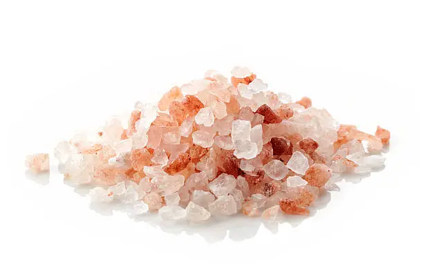 heap of pink himalayan salt isolated on white background