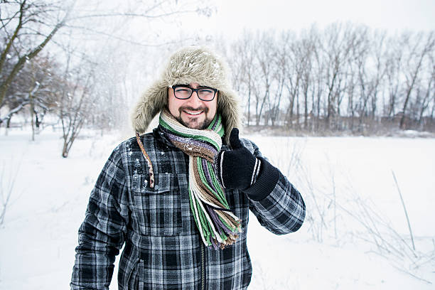 istock man in a fur hat. thumbs up 504928996