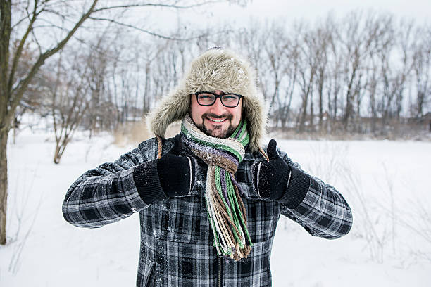 istock man in a fur hat. thumbs up 504929532