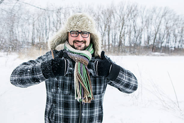 istock man in a fur hat. thumbs up 504929588