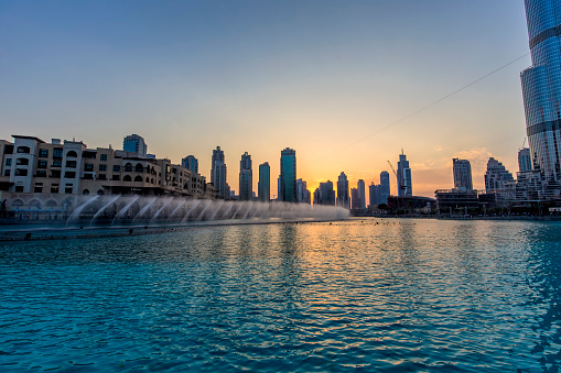 Dubai, United Arab Emirates - November 23, 2015: Wide view of the new lake of Dubai Fountain at sunset