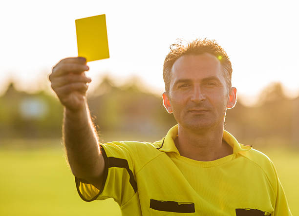 istock Soccer referee showing yellow card at sunset. 504930870