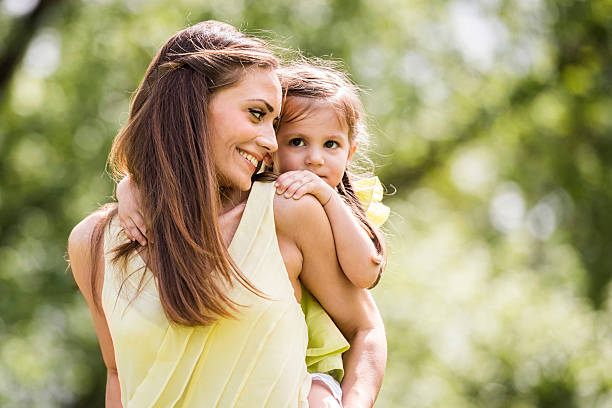 istock Affectionate mother piggybacking her daughter in the park. 504932630