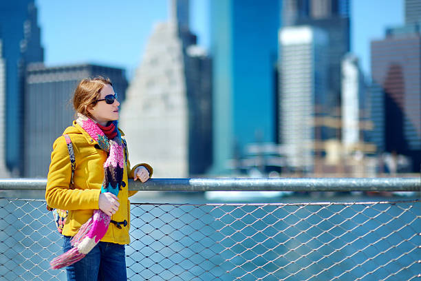 istock Young woman sightseeing by Brooklyn Bridge 504980970