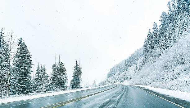 Empty road with snow covered landscape in winter season. stock photo