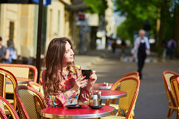 istock Beautiful young woman in Paris, drinking coffee 504983372