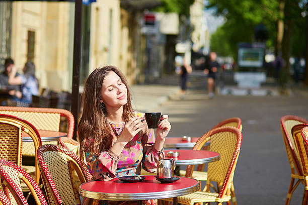 istock Beautiful young woman in Paris, drinking coffee 504983532