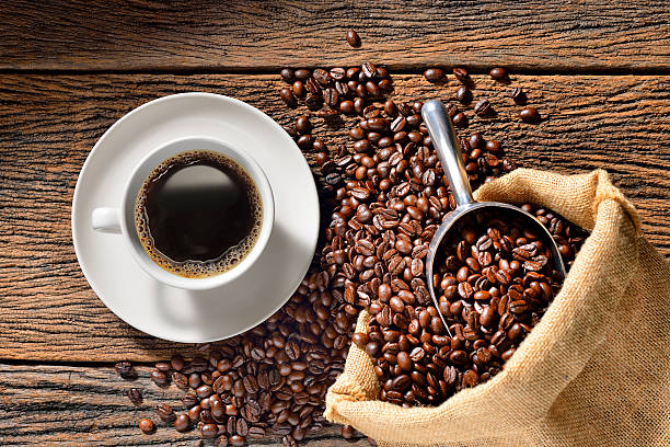 Cup of coffee Cup of coffee and coffee beans on wooden table caffeine photos stock pictures, royalty-free photos & images