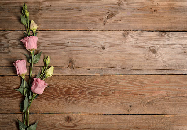 istock Beautiful eustoma on wooden background 504984612