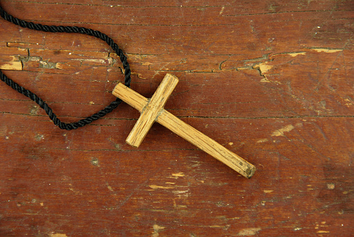 Old wooden cross with rope