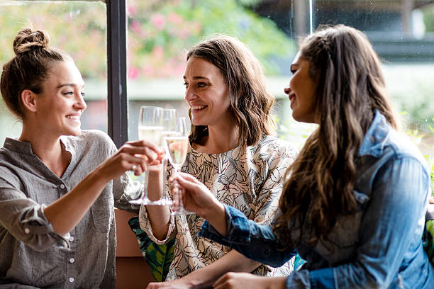 Cheers to good party Three cute girlfriends celebrating with champagne at good party. only young women stock pictures, royalty-free photos & images