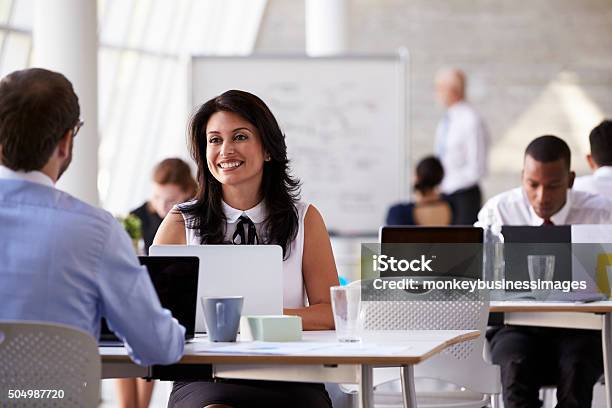 Businesspeople Working At Desks In Modern Office Stock Photo - Download Image Now - 20-29 Years, 30-39 Years, 40-49 Years