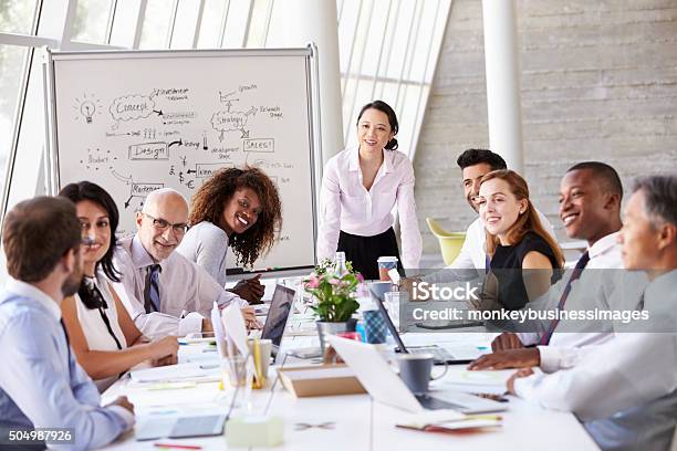 Asian Businesswoman Leading Meeting At Boardroom Table Stock Photo - Download Image Now