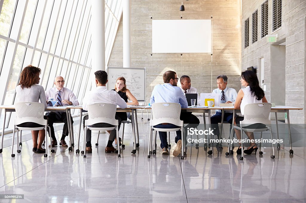 Group Business Meeting Around Table In Modern Office Open Plan Stock Photo