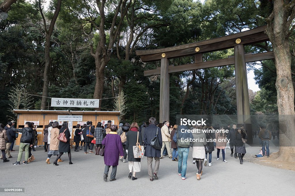 Meiji Shrine in Tokyo, Japan Tokyo, Japan - January 11, 2016 : People at the Meiji Shrine in Tokyo, Japan. Japanese go to Shrine to ask for health, wealth and divine protection during the New year.  Architecture Stock Photo