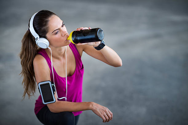 istock Sportswoman drinking energy drink 504992702