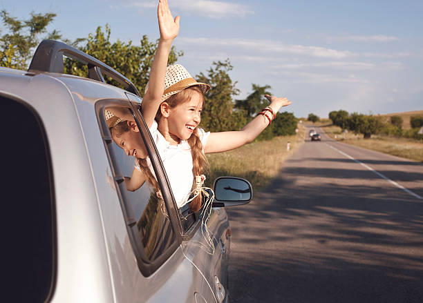 istock Raising hands from the car  window 504992704