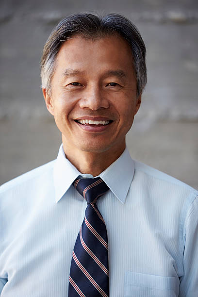 istock Asian Businessman Standing Against Wall In Modern Office 504996686