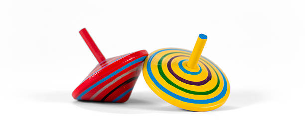 istock Two wooden and colorful spinning tops 505015400