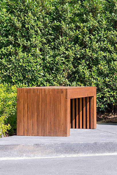 istock wood bench in garden with small green tree in background 505016090