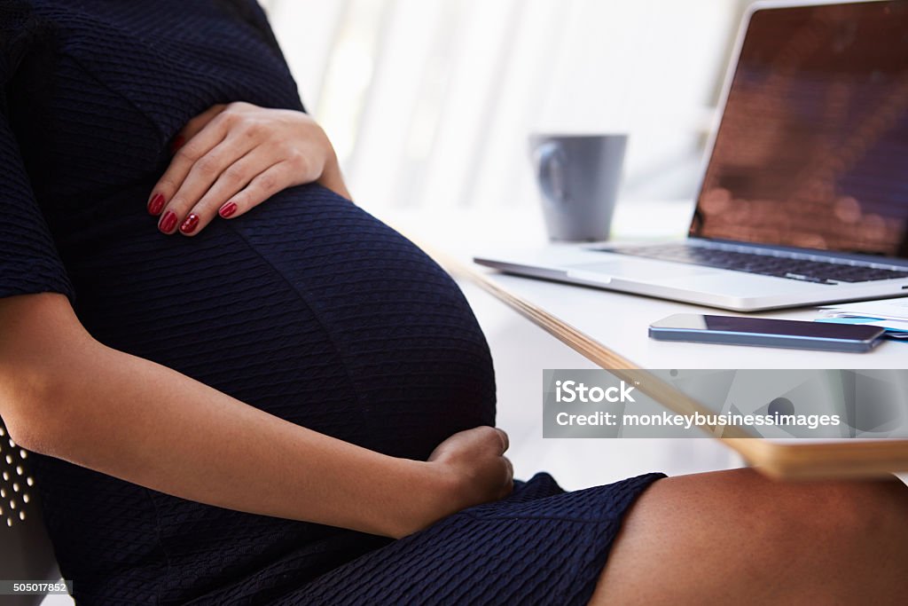 Close Up Of Pregnant Businesswoman In Office Pregnant Stock Photo