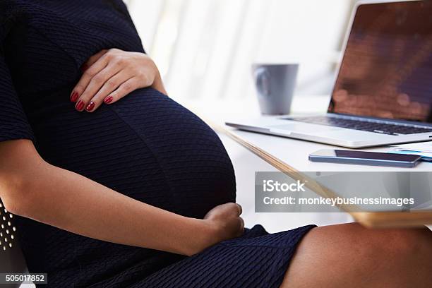 Close Up Of Pregnant Businesswoman In Office Stock Photo - Download Image Now - Pregnant, One Woman Only, Women