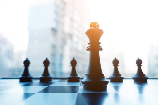 One Chess Piece is with a full set of chess strategy, planning and decision making concepts. Chess strategic business plan on businesspeople background