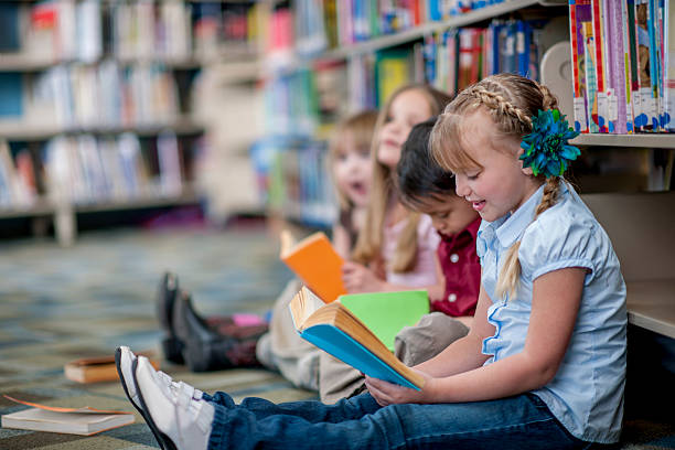 istock Children Reading Books in the Library 505018926