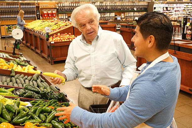 istock Senior man purchasing fresh vegetables from produce section in supermarket 505018944