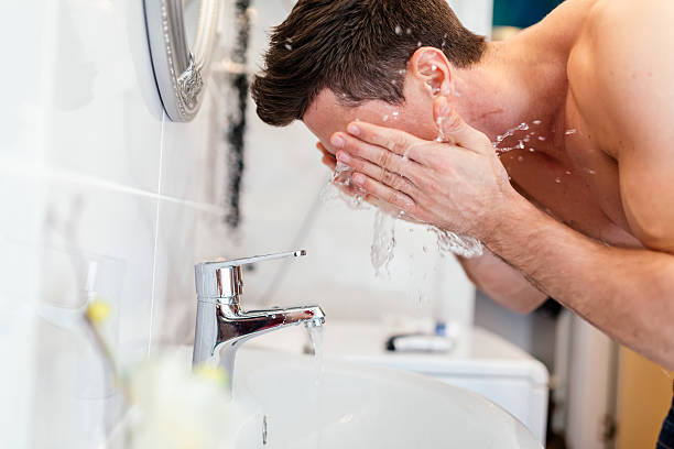 istock Handsome man washing face in bathroom 505020006