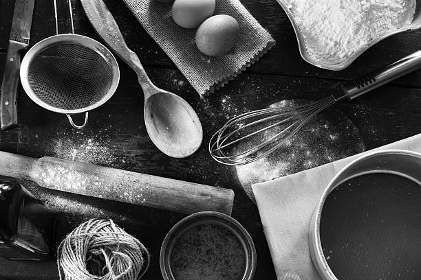 Kitchen table in a rustic style A set of old kitchen items close-up view from above. Kitchen table in a rustic style. Products for baking flour, eggs, salt. Black and white photo buckwheat photos stock pictures, royalty-free photos & images