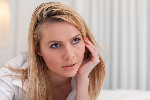 istock Seductive blonde lying on bed in man's shirt 505020612