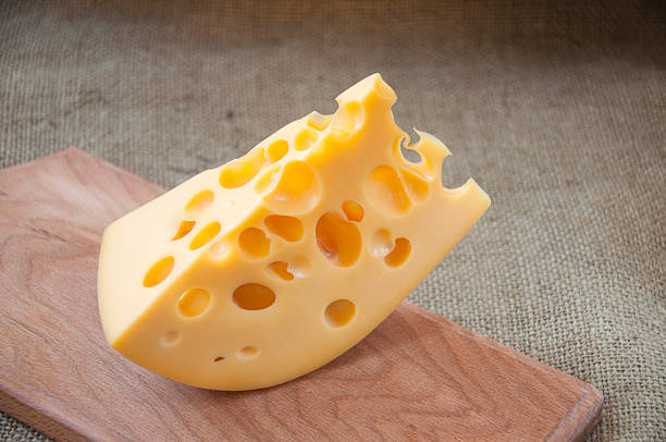 cheese on wooden cutting board stock photo