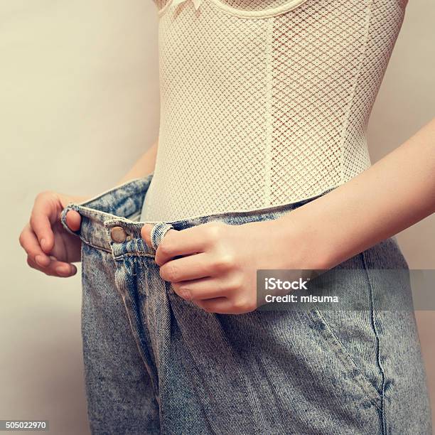 Woman Dressed Over Size Blue Old Style Jeans Copy Space Stock Photo - Download Image Now