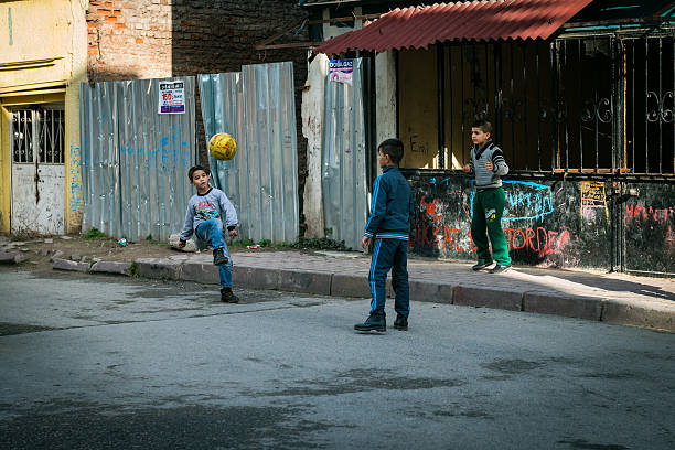 Istanbul, Turkey - January 12, 2016: Three boys are playing ball in the street of Istanbul, Turkey