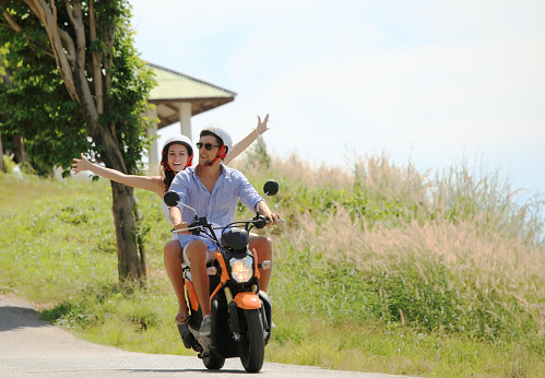 Happy couple on a scooter at summer vacation
