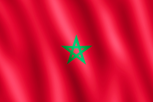 Flag of Morocco waving in the wind giving an undulating texture of folds in the fabric. The Image is in the official ratio of the flag - 2:3.