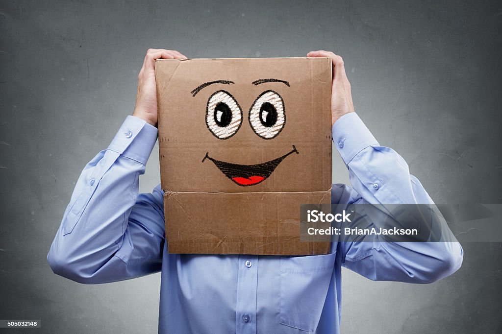 Businessman with cardboard box on his head Businessman with cardboard box on his head with smiling expression concept for happiness, excitement, enthusiastic or success Anthropomorphic Smiley Face Stock Photo