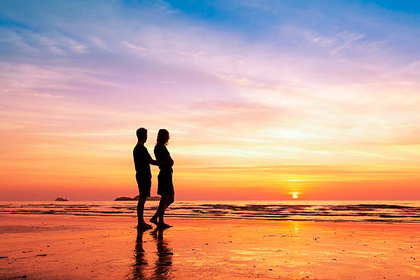 istock Couple sharing a romantic moment together on the beach, sunset 505032896