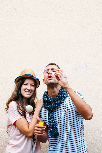 istock Beautiful young couple blowing soap bubbles. 505045455