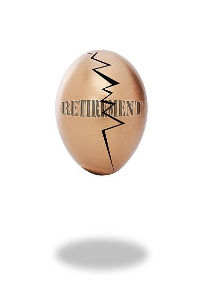 Cracked Retirement Egg. Broken and cracked retirement egg. golden nest egg taxes stock pictures, royalty-free photos & images