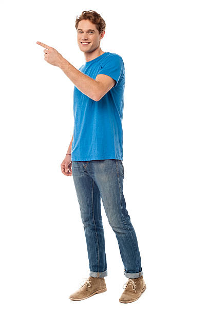 istock Smiling young man pointing to the side 505047731