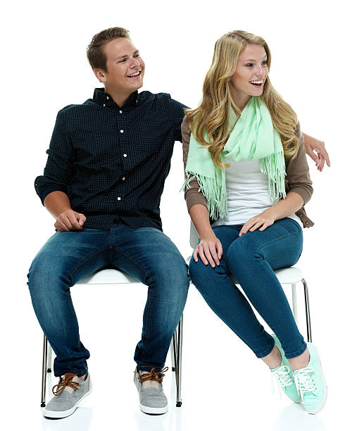 istock Smiling couple sitting on chair & looking away 505049383