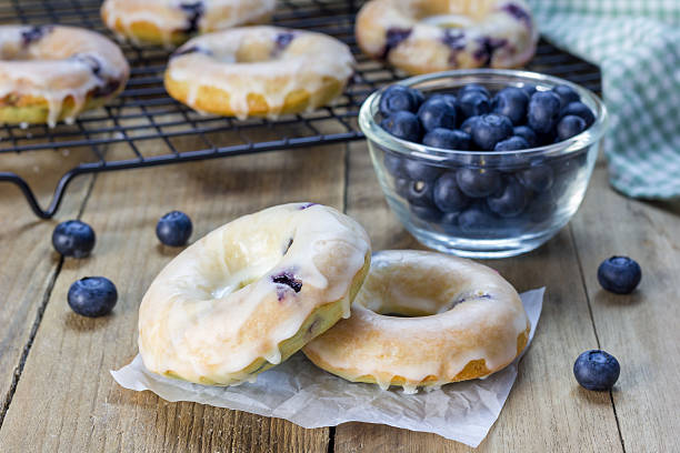 istock Freshly baked baked doughnuts with blueberries and lemon glaze 505057026